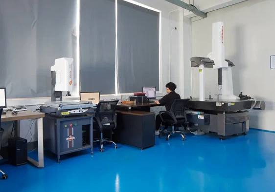 Quality engineer inspecting custom CNC machined parts with CMM at Dazao Machinery Quality engineer inspecting custom CNC machined parts with CMM at Dazao Machinery